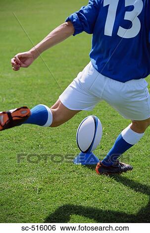 Stock Photograph - Rugby Player Kicking A Rugby Ball From A Set Peice. Fotosearch