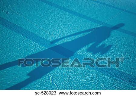 Stock Image - Shadow of a person on pool. Fotosearch