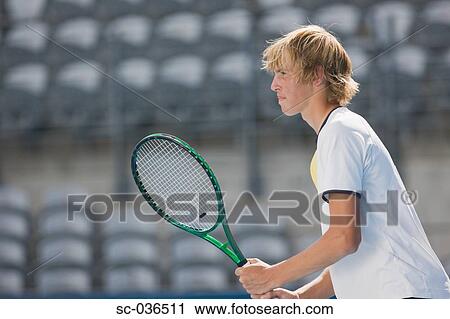 Side view of male tennis player View Large Photo Image Stock Image - Side view of male tennis player. Fotosearch