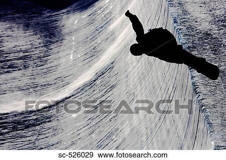 Stock Photo - Silhouette of a person snowboarding. Fotosearch