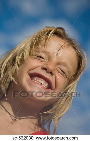Stock Image - Smiling soccer player with squinting eyes . Fotosearch