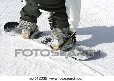 Snowboarder checking boots View Large Photo Image Stock Photography - Snowboarder checking boots. Fotosearch