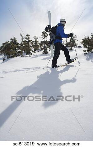 Stock Photo - Snowboarder trudging through snow. Fotosearch
