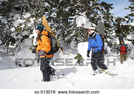 Stock Photo - Snowboarders trudging through snow. Fotosearch