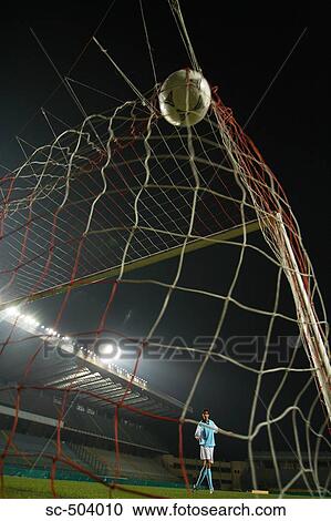Stock Image - Soccer Ball Entering A Net. Fotosearch