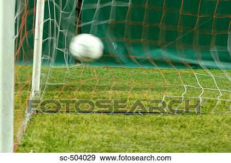 Stock Photo - Soccer Ball Entering Net. Fotosearch