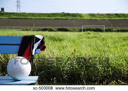 Soccer Ball Lying On a Bench In a Field View Large Photo Image Stock Photo - Soccer Ball Lying On a Bench In a Field. Fotosearch