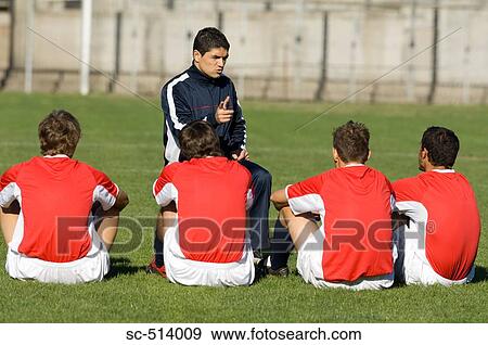 Stock Photo - Soccer coach giving advice to players. Fotosearch