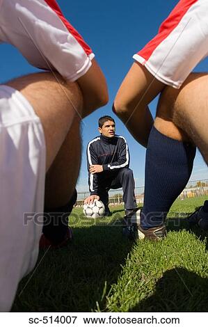 Soccer coach kneeling View Large Photo Image Stock Photo - Soccer coach kneeling. Fotosearch