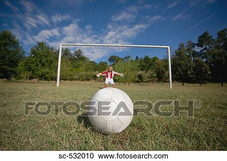 Stock Image - Soccer goalkeeper diving for ball. Fotosearch