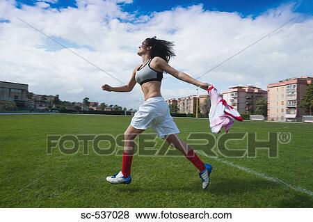 Stock Photo - Soccer player celebrating success. Fotosearch