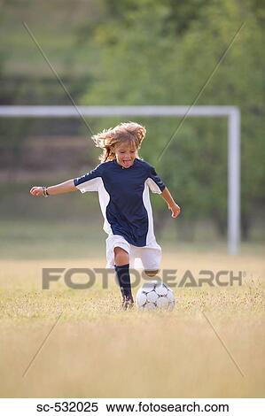 Soccer player cheering and kicking football View Large Photo Image Stock Photography - Soccer player cheering and kicking football. Fotosearch