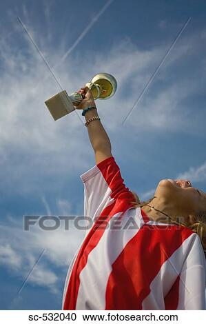 Soccer player cheering with trophy View Large Photo Image Stock Image - Soccer player cheering with trophy. Fotosearch
