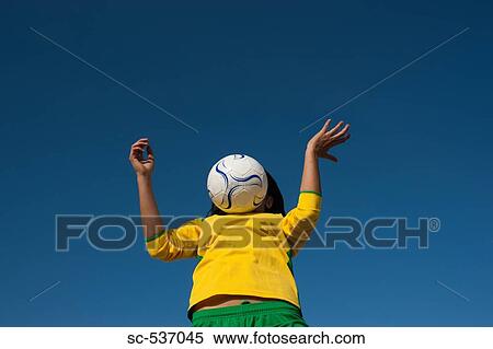 Stock Photography - Soccer player chesting soccer ball. Fotosearch