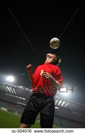 Stock Photograph - Soccer Player Heading a Ball. Fotosearch