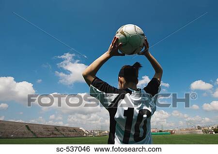 Stock Photograph - Soccer player holding soccer game. Fotosearch