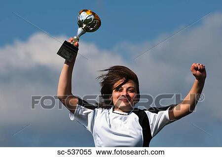 Soccer player holding trophy View Large Photo Image Stock Photography - Soccer player holding trophy. Fotosearch