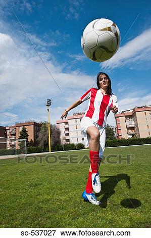 Stock Photo - Soccer player juggling soccer ball. Fotosearch