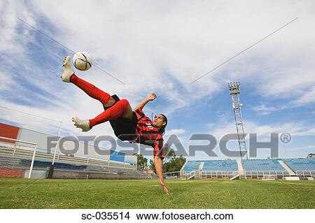 Picture - Soccer player performing aerial kick. Fotosearch