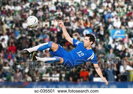 Stock Image - Soccer player performing aerial kick. Fotosearch
