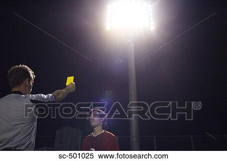 Stock Photography - Soccer Player Receiving Yellow Card Warning From Ref. Fotosearch