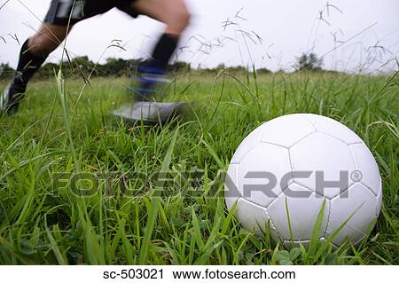 Stock Image - Soccer Player Running To Kick A Soccer Ball. Fotosearch