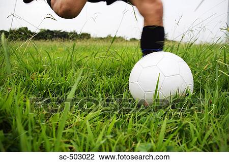 Stock Image - Soccer Player Running To Kick A Soccer Ball. Fotosearch