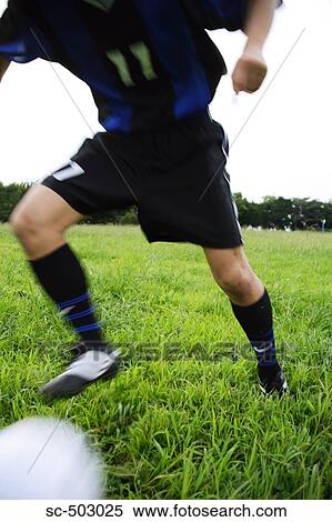 Soccer Player Running To Kick A Soccer Ball View Large Photo Image Stock Photography - Soccer Player Running To Kick A Soccer Ball. Fotosearch
