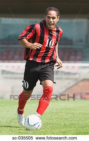 Stock Photography - Soccer player running with ball. Fotosearch