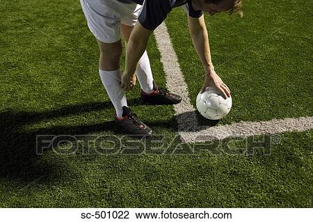 Stock Image - Soccer Player Setting Up A Corner Kick. Fotosearch