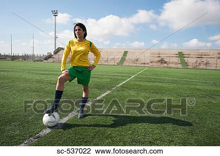 Stock Image - Soccer player standing in stadium. Fotosearch