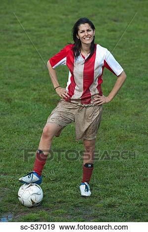 Stock Photo - Soccer player standing with hands on hips. Fotosearch