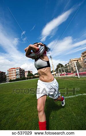 Stock Photo - Soccer player stripping soccer uniform. Fotosearch