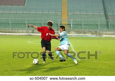 Soccer Player Tackling View Large Photo Image Stock Photo - Soccer Player Tackling . Fotosearch