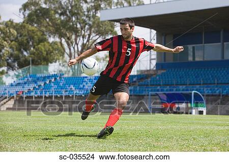Picture - Soccer player taking a shot. Fotosearch