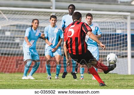 Stock Image - Soccer player taking freekick. Fotosearch