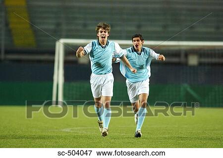Stock Photo - Soccer Players Celebrating Goal. Fotosearch
