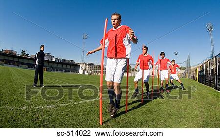 Soccer players doing training drills View Large Photo Image Stock Image - Soccer players doing training drills . Fotosearch