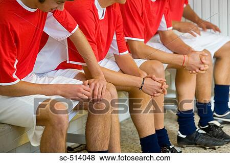 Stock Photo - Soccer players sitting on a bench. Fotosearch