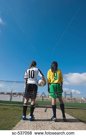 Stock Photo - Soccer players standing in stadium. Fotosearch
