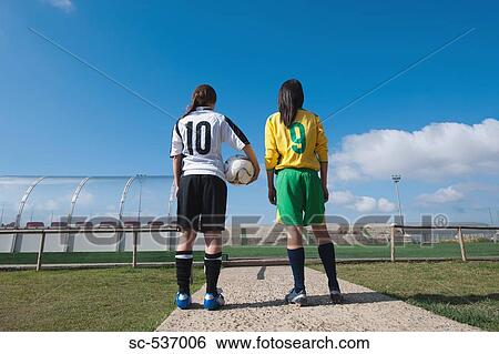 Stock Photograph - Soccer players standing in stadium. Fotosearch