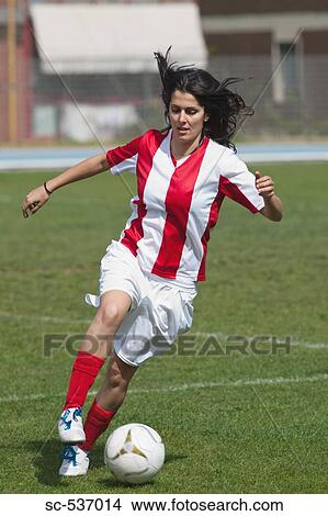 Sportswoman dribbling soccer ball View Large Photo Image Picture - Sportswoman dribbling soccer ball. Fotosearch