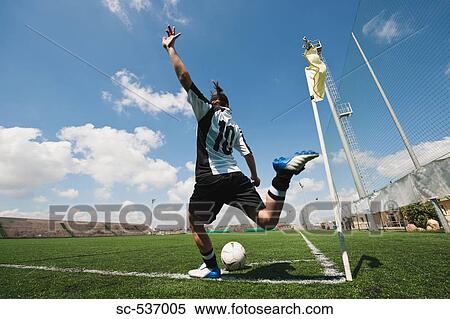 Stock Photography - Sportswoman kicking soccer ball . Fotosearch
