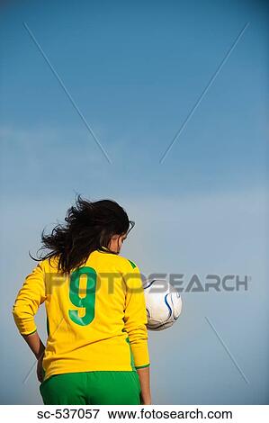 Stock Photo - Sportswoman playing soccer. Fotosearch