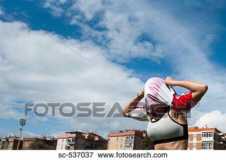 Stock Photo - Sportswoman with obscured face. Fotosearch