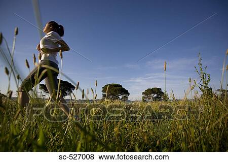 Teenager girl jogging in countryside View Large Photo Image Stock Photo - Teenager girl jogging in countryside. Fotosearch