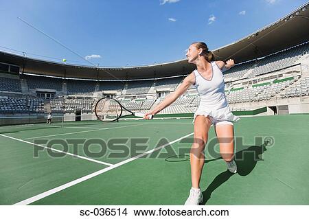 Picture - Tennis player hitting backhand return. Fotosearch