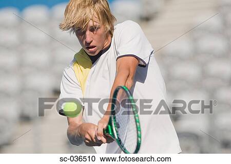 Tennis player hitting backhand return View Large Photo Image Stock Image - Tennis player hitting backhand return. Fotosearch