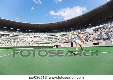 Tennis player hitting backhand return View Large Photo Image Stock Image - Tennis player hitting backhand return. Fotosearch