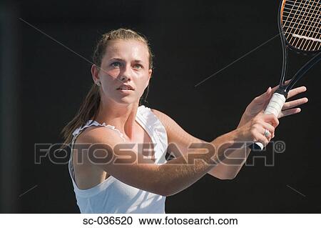 Stock Image - Tennis player hitting backhand return. Fotosearch